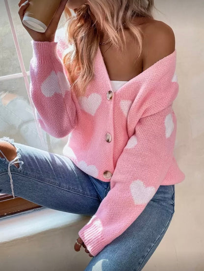Rožinis moteriškas megztinis su širdelių raštu